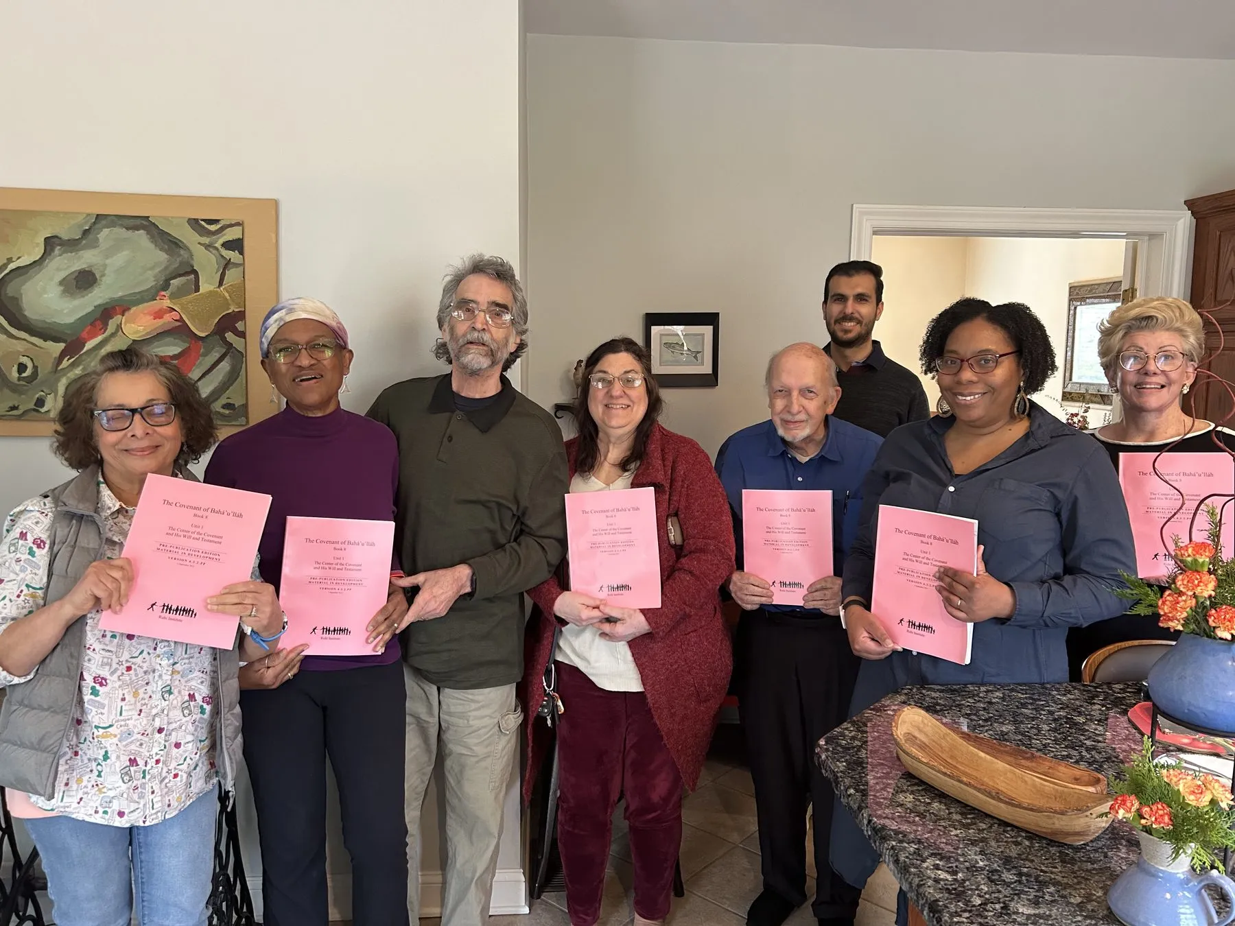Friends from the community holding study booklets after a gathering