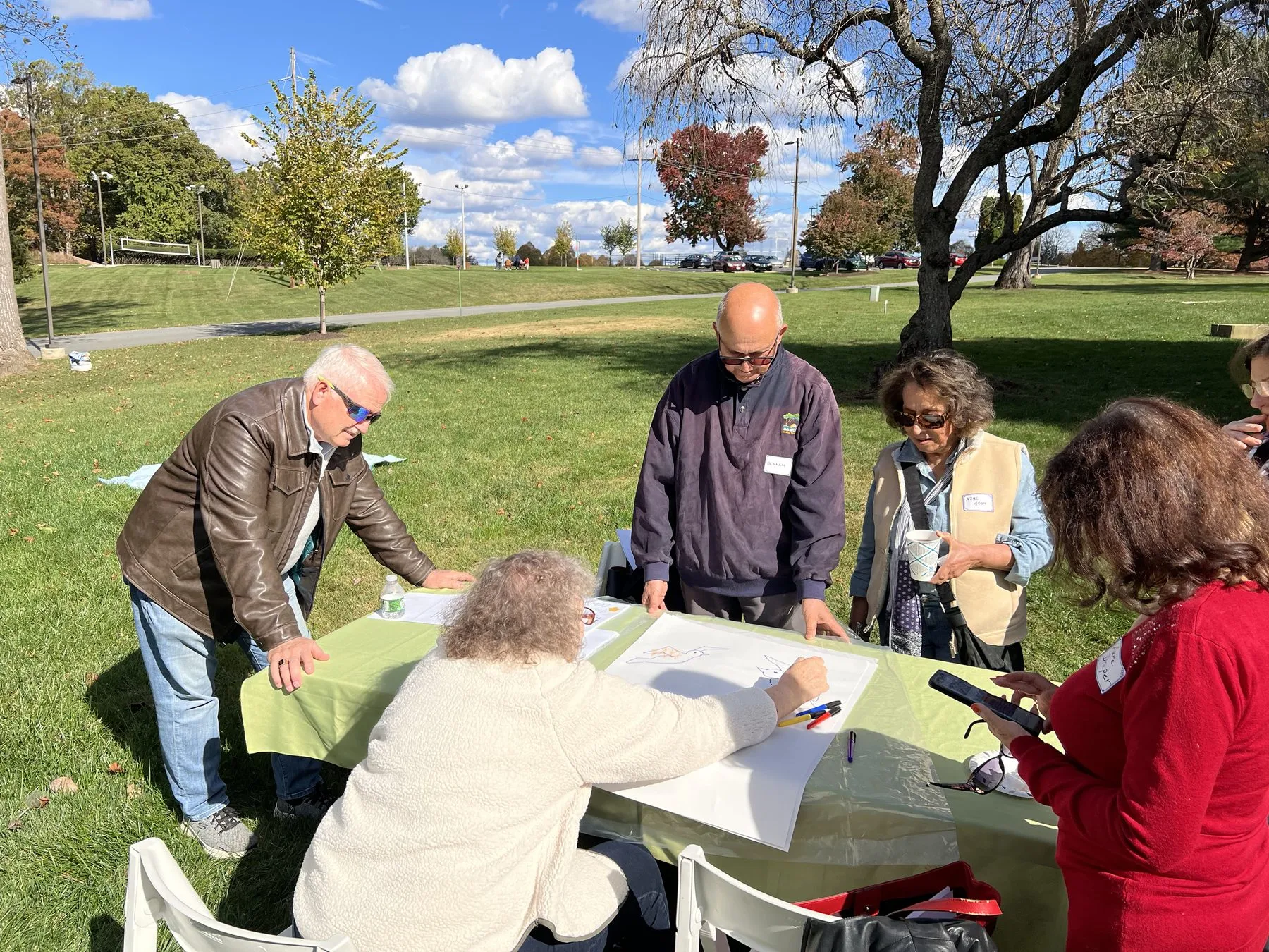 Friends studying together outdoors on an autumn afternoon